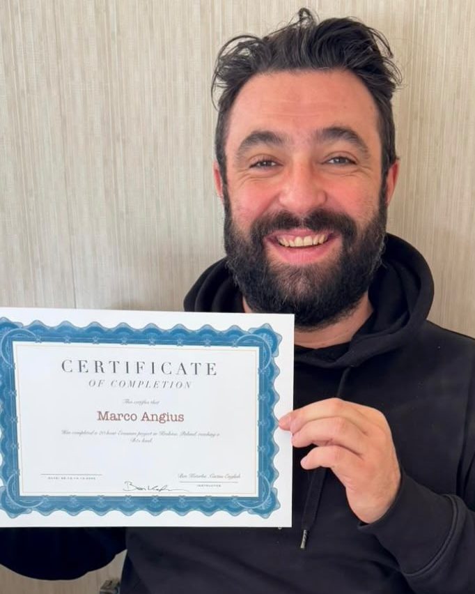 Participant holding a certificate of completion