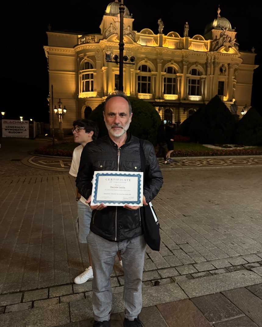Participant with a certificate in front of the Juliusz Słowacki Theatre in Kraków